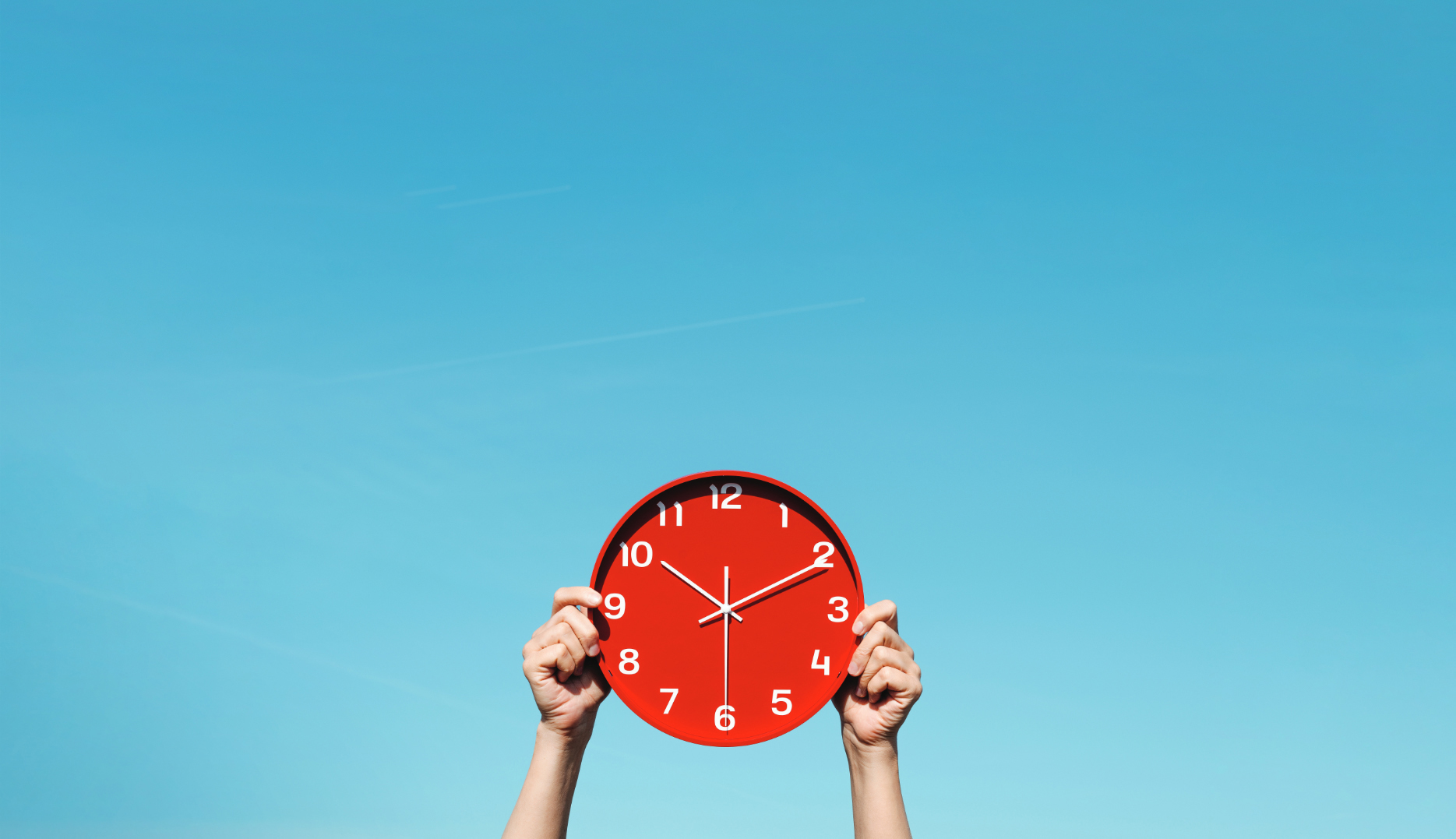 Hands holding up red clock