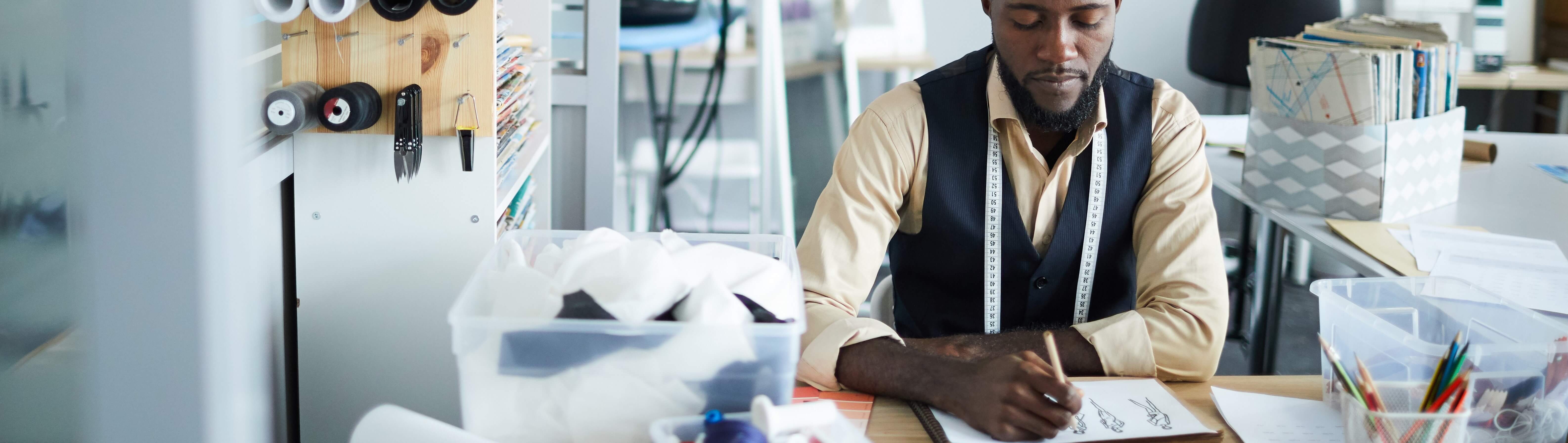 Man sketching at a desk.