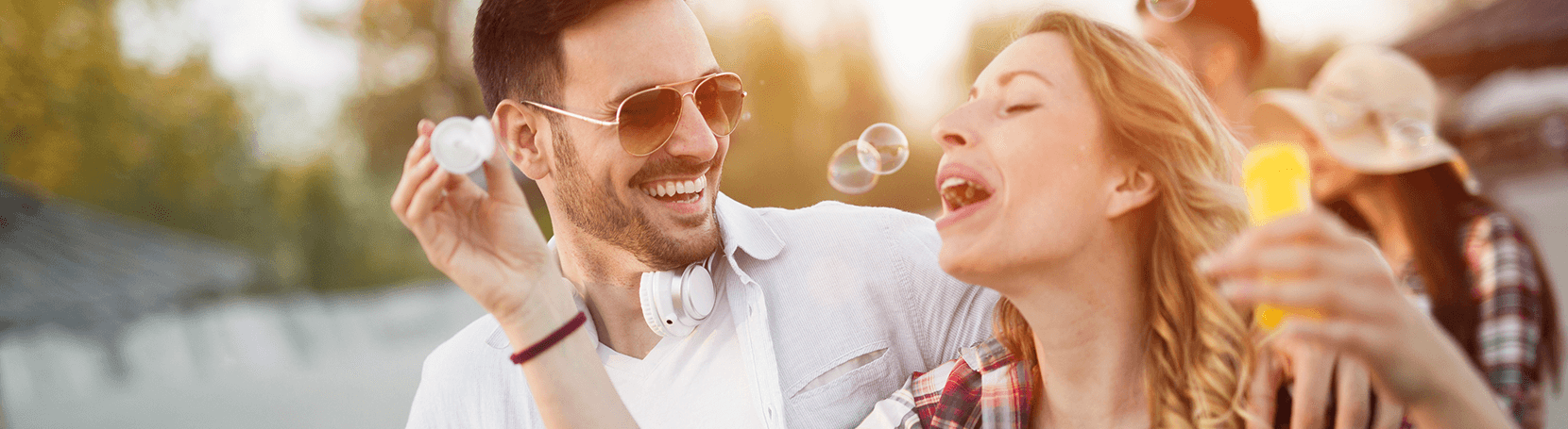 Happy couple blowing bubbles.